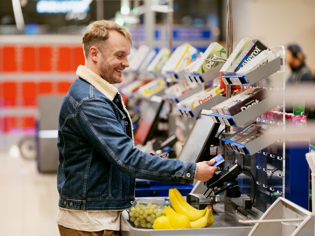 Mann mikrosparer til buffer når han handler på butikken